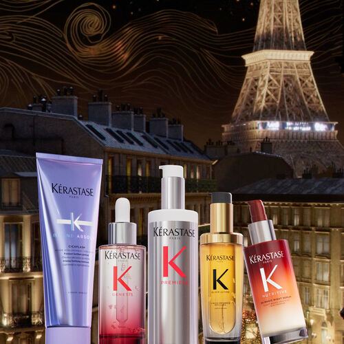 A collection of Kerastase hair care products displayed against a backdrop of the Eiffel Tower and a night sky, highlighting their luxurious branding.