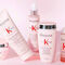 A collection of Kerastase Genesis hair care products displayed on a light pink background, including a shampoo, conditioner, serum, and a restorative mask, all featuring the brand's logo.
