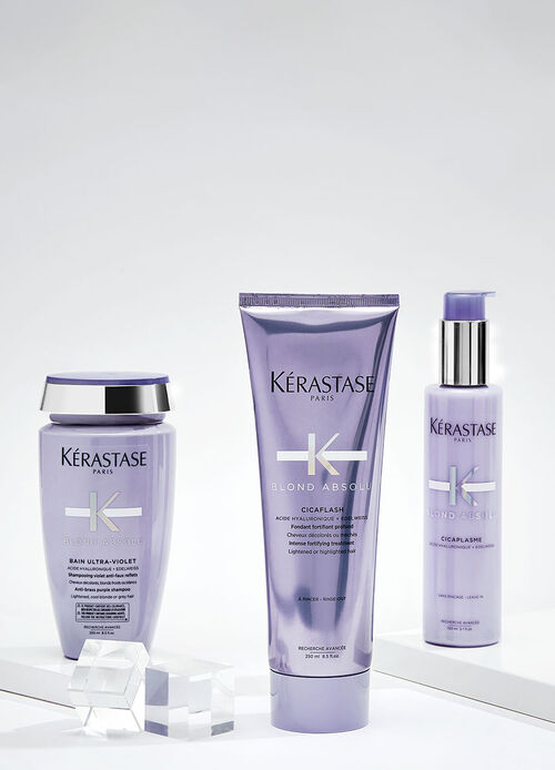 Imagen de varios productos de la marca Kerastase, incluyendo frascos de diferentes tamanos y formulas para el cuidado del cabello, dispuestos sobre un fondo blanco.