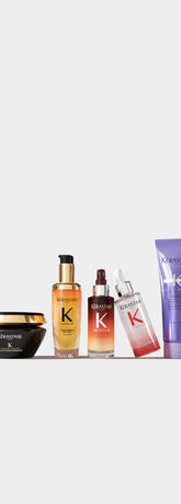 Cuatro productos de cuidado del cabello de la marca Kerastase sobre un fondo blanco, dispuestos artisticamente.