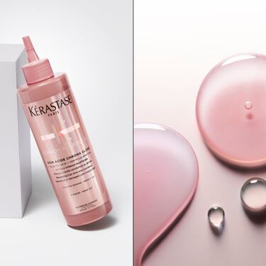 El fondant soin acide chroma gloss Kerastase se coloca de pie sobre una base transparente.