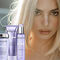 A model with long, light blonde hair is featured prominently alongside Kerastase hair care products displayed in the foreground, including shampoo, conditioner, and a treatment. The background has a soft, blurred effect, creating a focus on the model and the products.