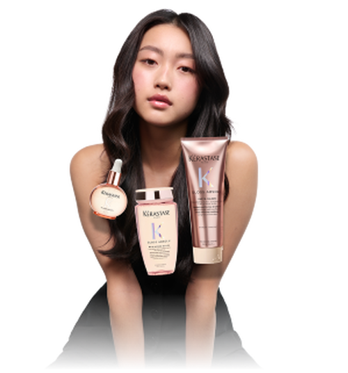 A model with long, dark hair holds hair care products from Kerastase's Gloss Appeal line, including a serum, shampoo, and conditioner, against a transparent background.