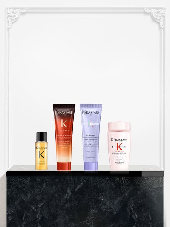 Cuatro productos Kerastase en miniatura en exhibicion: el aceite Elixir Ultime, el Nutritive Magic Night Serum, el tratamiento Cicaflash de la gama Blond Absolu y un producto de la linea Kerastase Genesis.