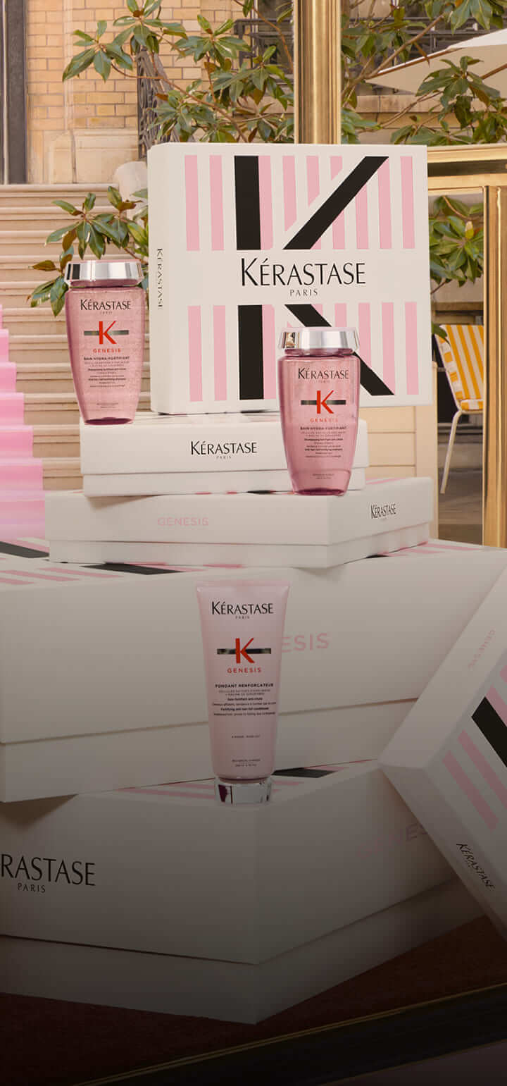 Presentación de productos de Kérastase en cajas elegantes, con enfoque en la línea Genesis para el cuidado del cabello.
